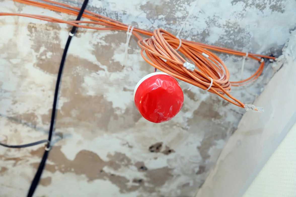 Fire alarm system wiring being tested for safety.